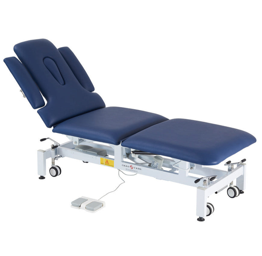 Electric aesthetic bed with cushioned surface and adjustable sections. Center view.